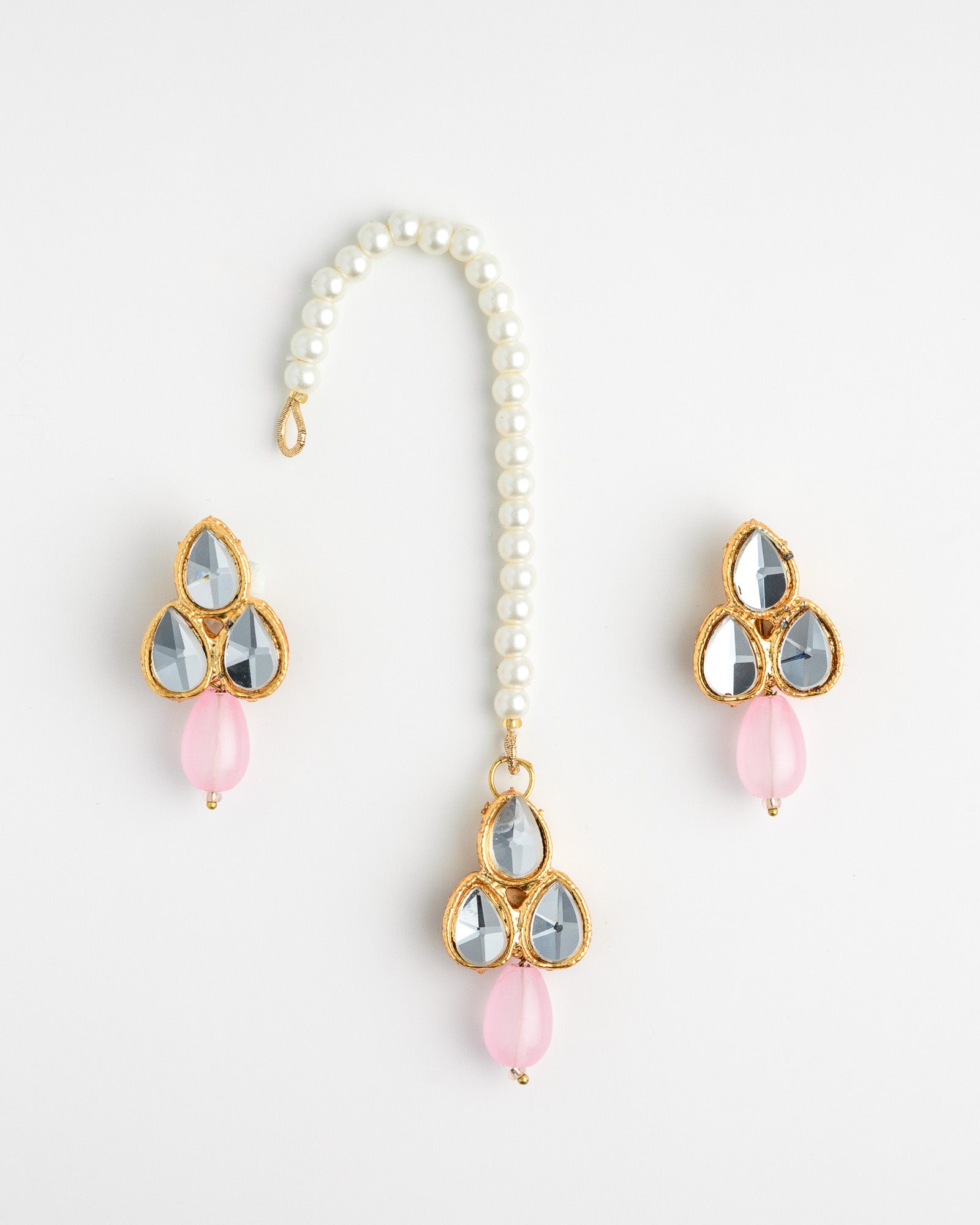 pink earring set with white beads and gold accents on a white background