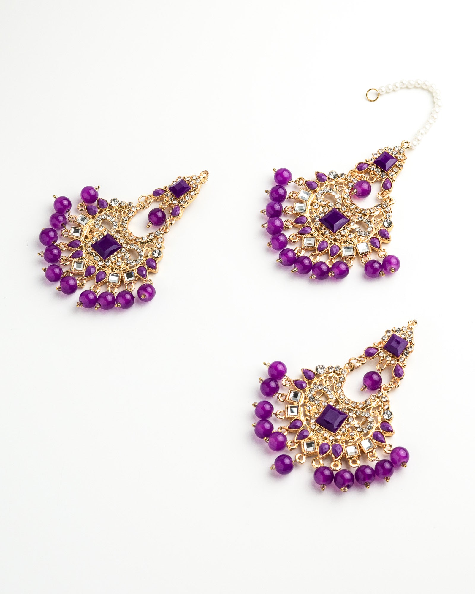 Purple beaded earring set with gold accents on a white background