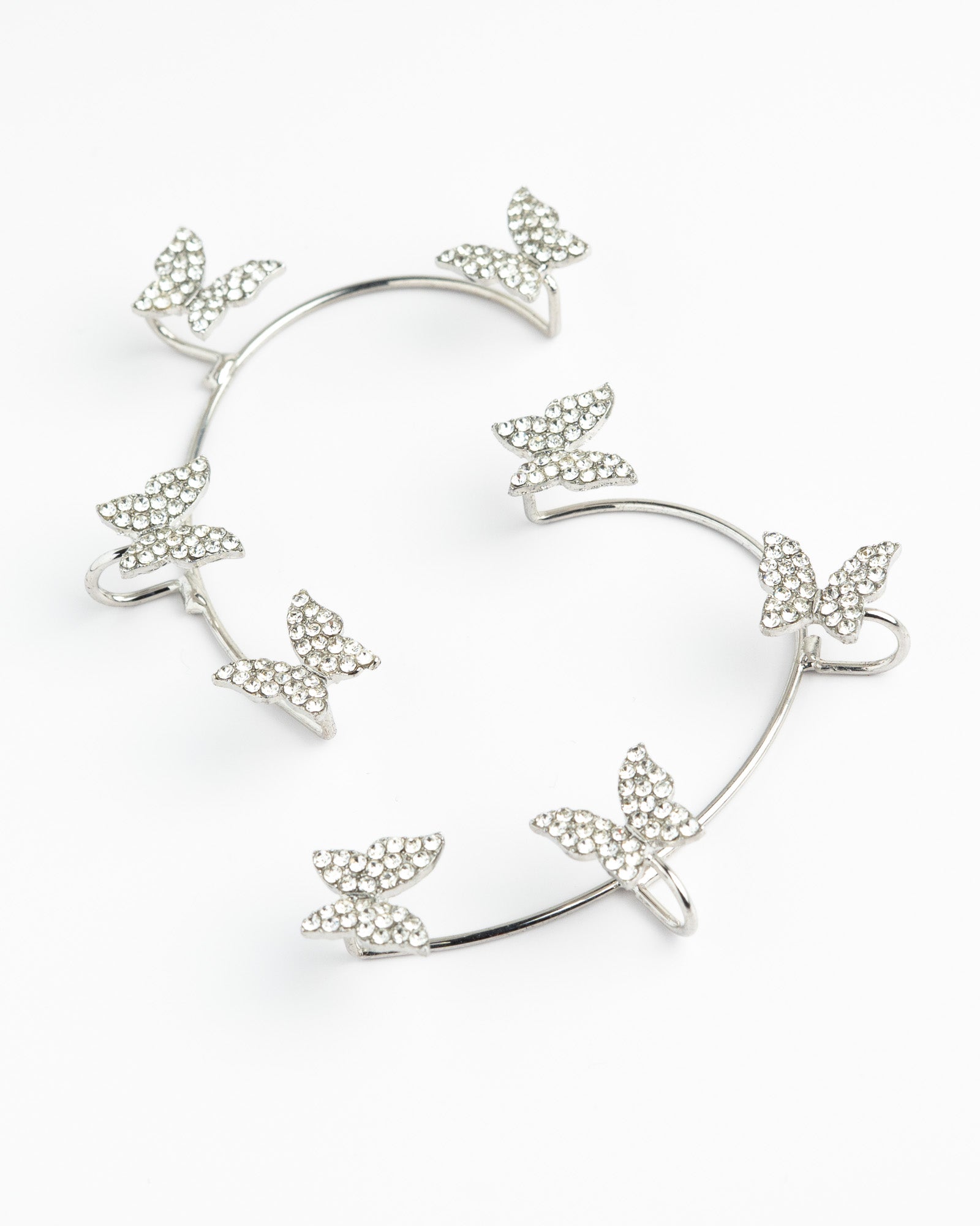 Heart-shaped earrings with silver floral elements on a white background