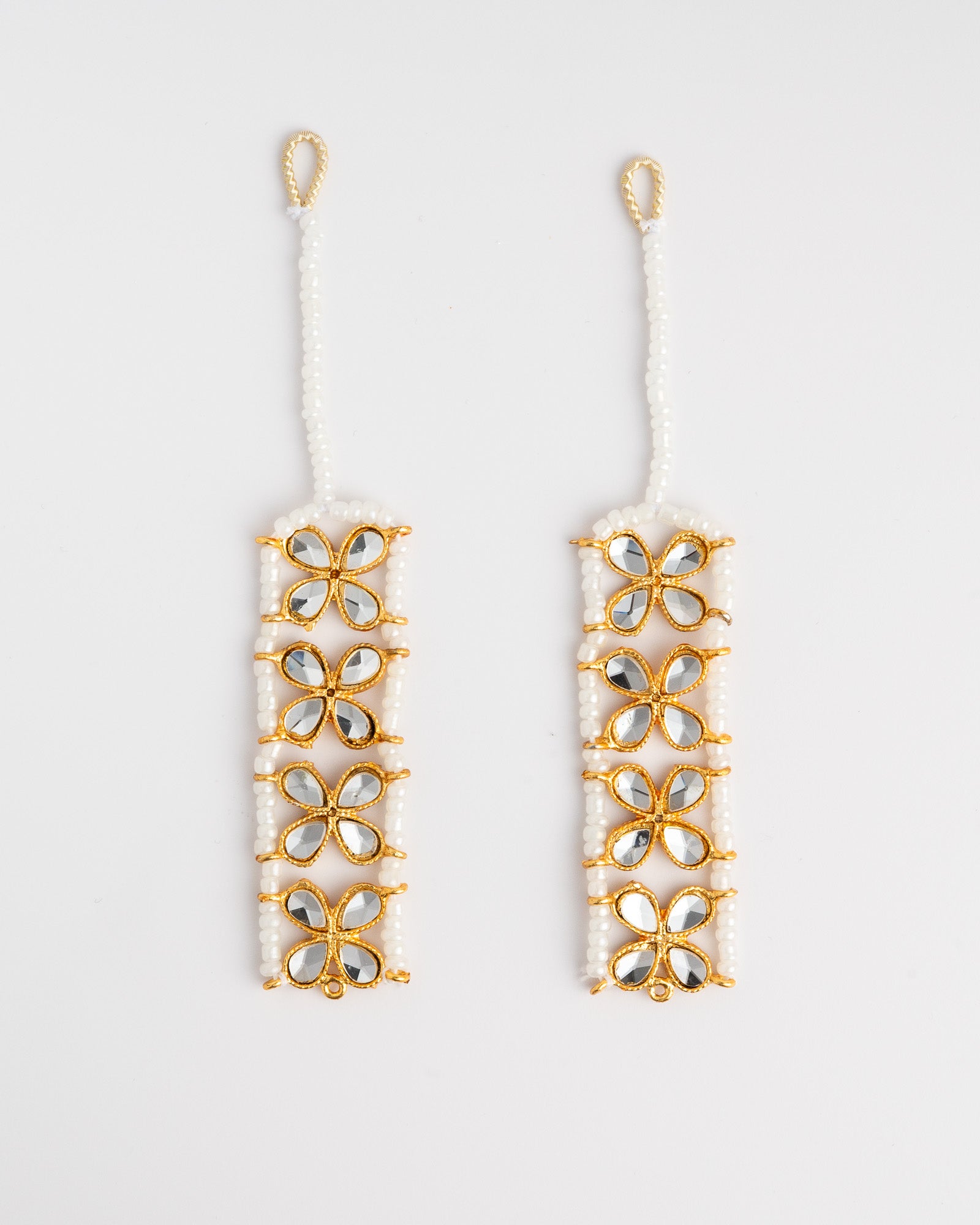 Pair of golden floral ear chain on a white background